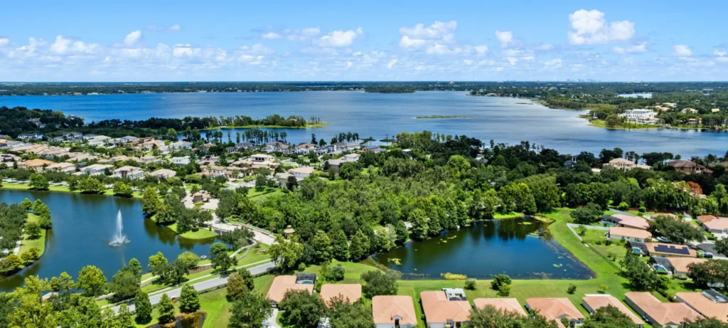 Aerial view of the Butler Chain of Lakes and luxury lakefront homes in Windermere, Florida with the Orlando skyline in the distance